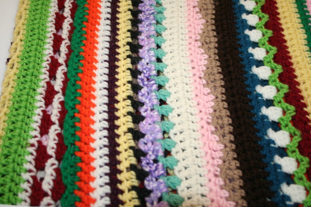 afgan with green orange, pink and white stripes