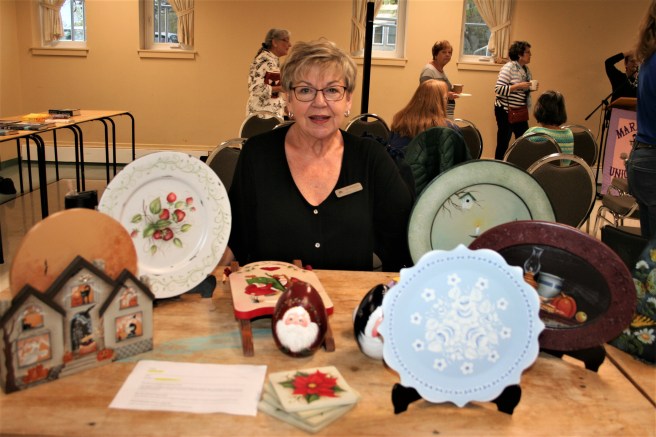 woman with folk art painted wall plates
