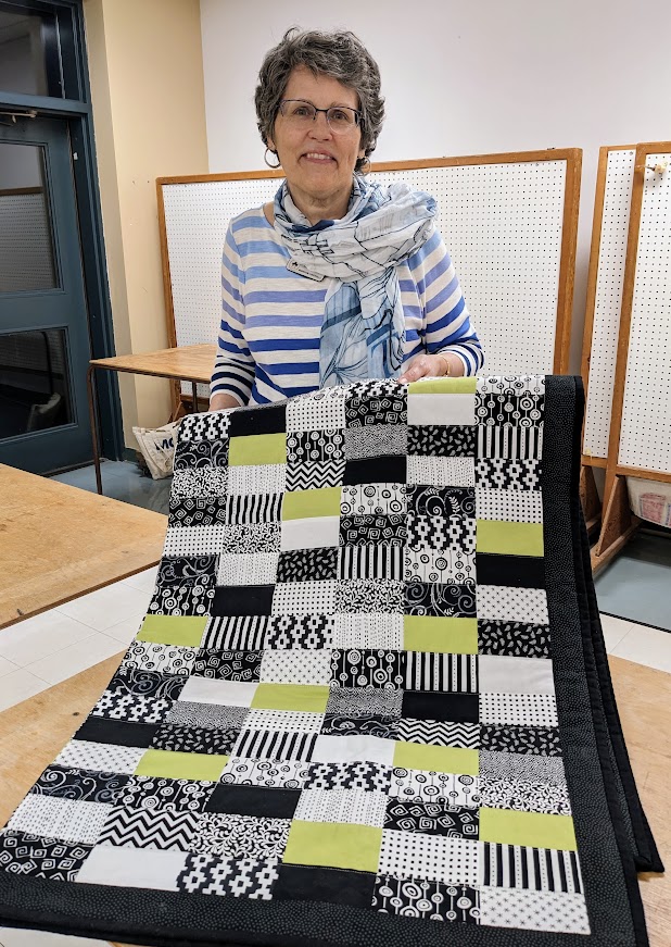 green black and white machine sewn quilt