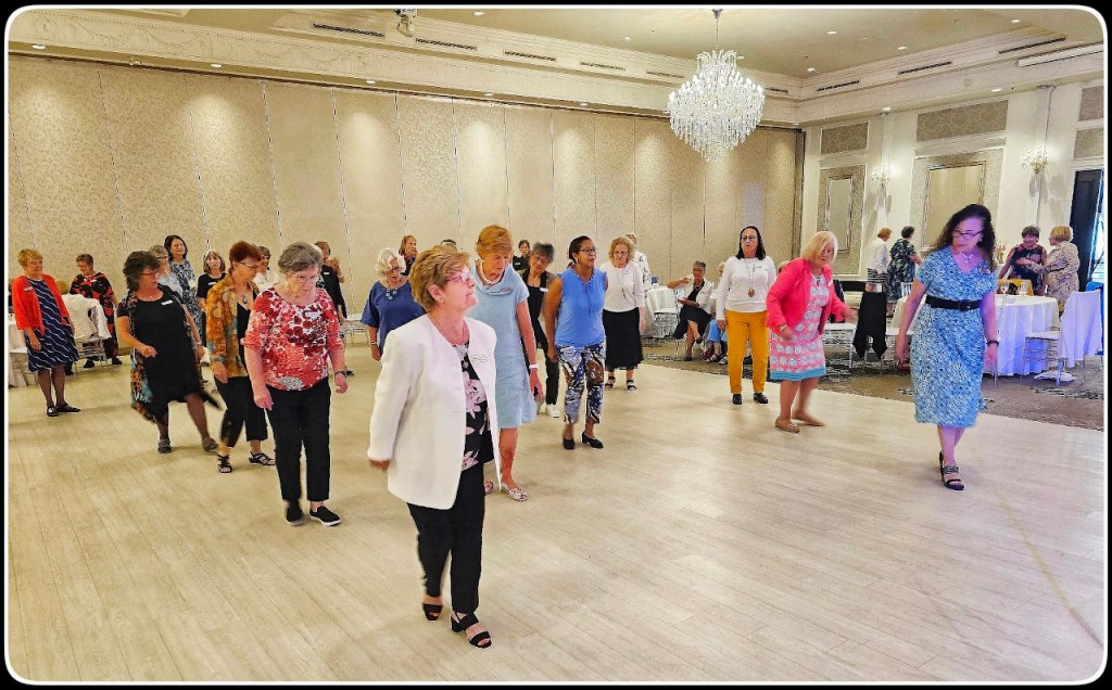 about 20 women line dancing