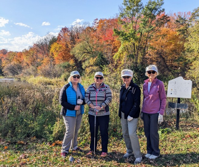 4 golfers at Markham Green with clubs in the fall