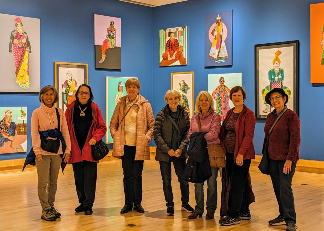 members of the Photography Group at the Varley art gallery in front of paintings by Meera Sethi