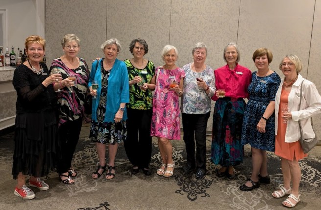 2025_05_27 9 colourfully dressed women at May banquet