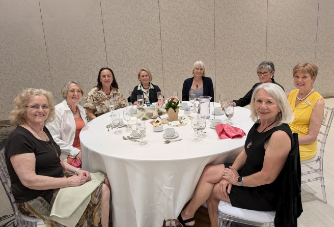 8 women enjoying friendly chats at May banquet