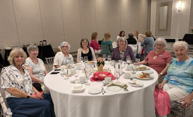 7 women enjoying chats at May banquet