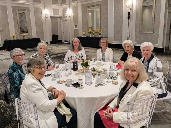 8 women smiling at May banquet