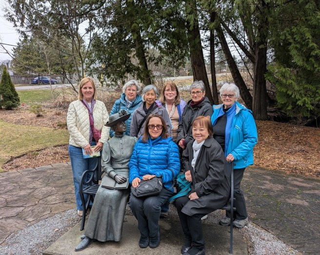 8 ladies with bronze of L M Montgomery